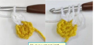 Close-up of white petals worked around a yellow crochet flower center