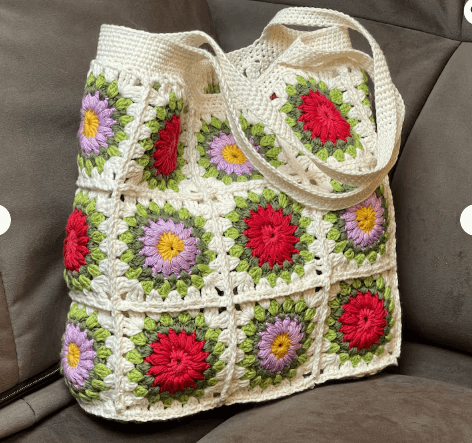 Close-up of the handle and seam on a crochet granny-square tote
